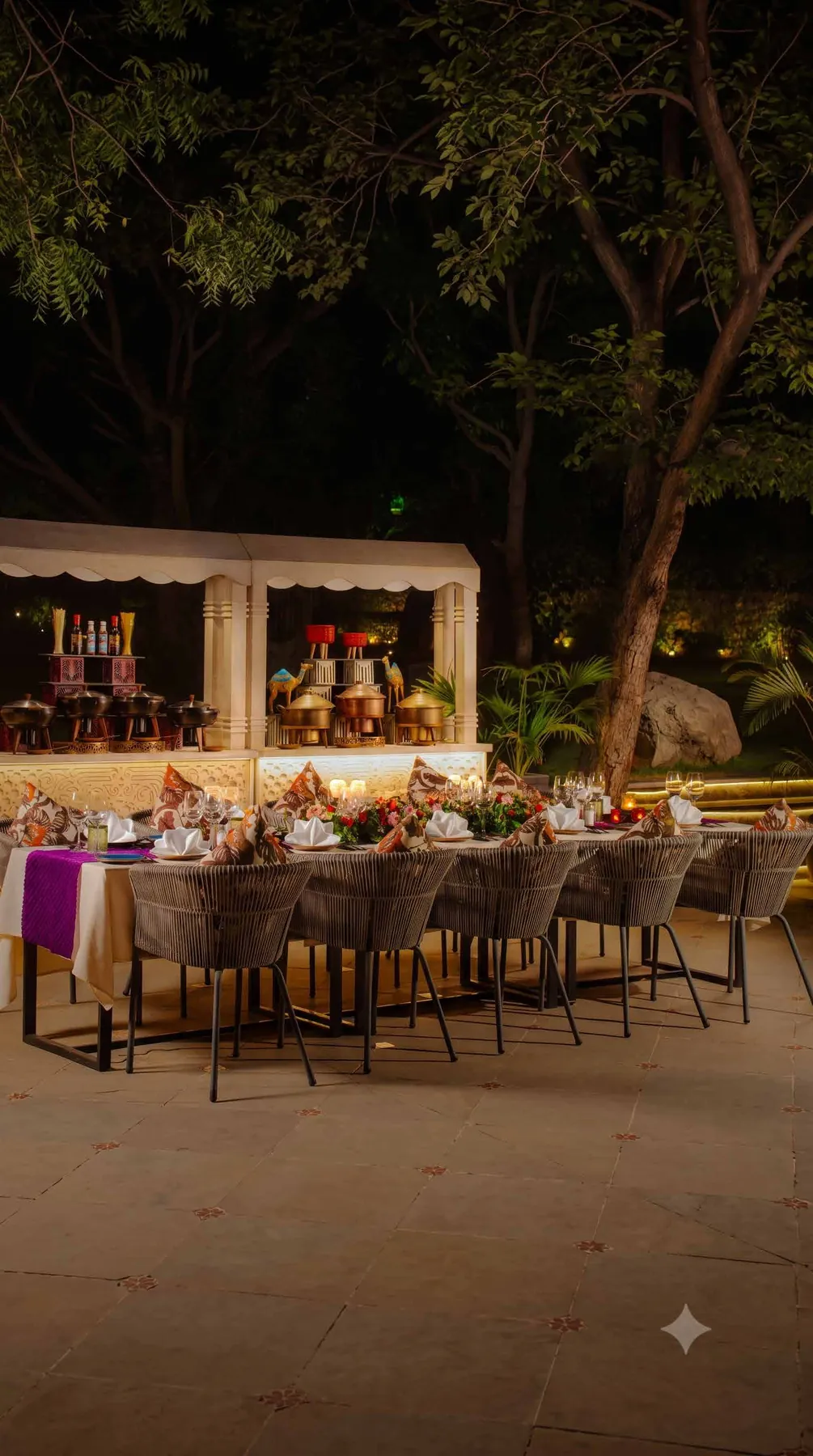 A lantern-lit banquet under the trees